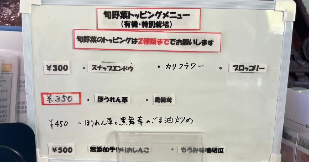 ホワイトボードに書かれているトッピングの旬野菜